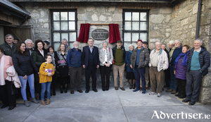 Many of the people active in Gluaiseacht Chearta Sibhialta na Gaeltachta stand at the commemorative plaque 50 years on. Pic:- Se&aacute;n &Oacute; Mainn&iacute;n