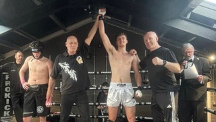  Belfast ref Robin Masters raises Sean Forrest’s hand in victory with coach Pete Foley at his side.