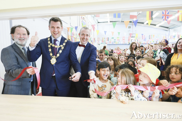 Mayor of Galway Cllr Eddie Hoare cuts the ribbon to open Galway Educate Together National School’s new Hot Lunch Kitchen on Friday. With The Mayor are Paddy Curley of Glanmor Foods, Hot Lunch Provider, Francis Duggan, principal and pupils of Galway Educate Together. Photo: Mike Shaughnessy 