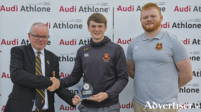 Buccaneers RFC president, Brendan Wilkins, makes an end of season presentation to Charlie O’Carroll in recognition of his playing for the Ireland U18 clubs team.  Sam Fogarty is also pictured.
