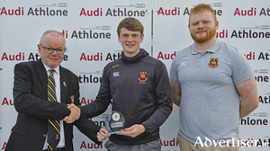 Buccaneers RFC president, Brendan Wilkins, makes an end of season presentation to Charlie O&rsquo;Carroll in recognition of his playing for the Ireland U18 clubs team.  Sam Fogarty is also pictured.
