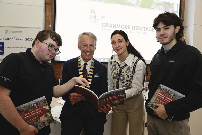 Cllr Liam Carroll, Cathaoirleach of the County of Galway and University of Galway students Dylan Reilly, Joseph Ennis and Natalie Cyrkle pictured with Opening The Door To Ireland's Heritage, a Heritage Council publication which features their work on the Galway County Heritage Trails project with Galway County Council. Photo Sean Lydon.