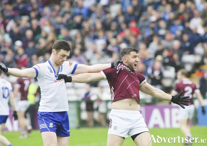 Galway’s Damien Comer protests being held by Monaghan’s Killian Lavelle in action from the GAA Football All Ireland preliminary quarter-final at Pearse Stadium on Sunday. [Photo: Mike Shaughnessy] 