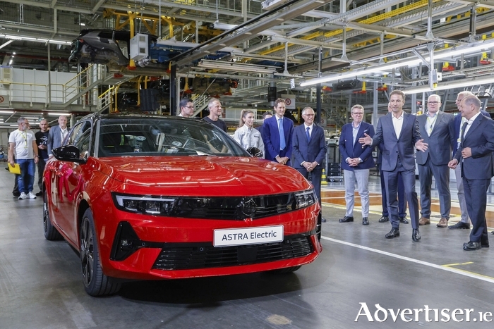 Opel CEO, Florian Huettl, speaks with German Chancellor, Olaf Scholz, about the fully electric Opel Astra at the Rüsselsheim plant. In the background from left to right: Stellantis Chairman, John Elkann; Stellantis CEO, Carlos Tavares; Chairman of the Supervisory Board of Opel Automobile GmbH, Xavier Chéreau. 