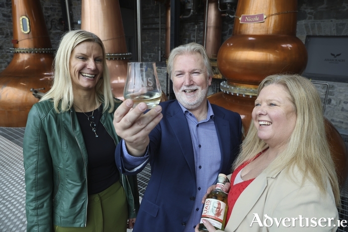 Minister of State for Land Use and Biodiversity, Pippa Hackett with Gareth and Michelle McAllister, founders of Ahascragh Distillery, on Monday. Photo: XPOSURE.ie.