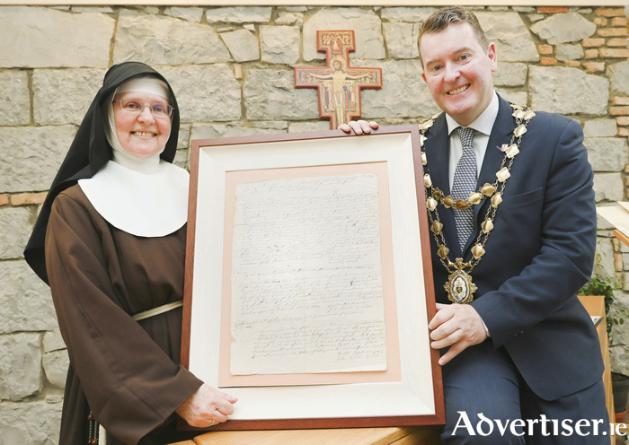 Mayor Peter Keane and Sister Colette, Abbess of the Galway Poor Clares, with the original deed of the land grant, dating back to 1649 when The Poor Clare Nuns were given the land where their convent remains today. 
Photo: Mike Shaughnessy