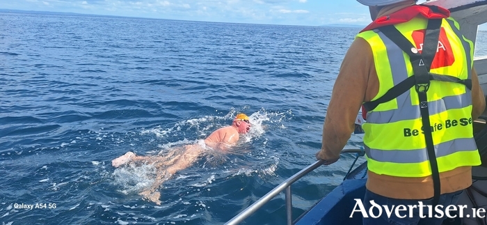 Inis Mór pilot John Conneely watching Fergal Somerville swim 34km through Galway Bay's tidal waters and Atlantic open ocean. 