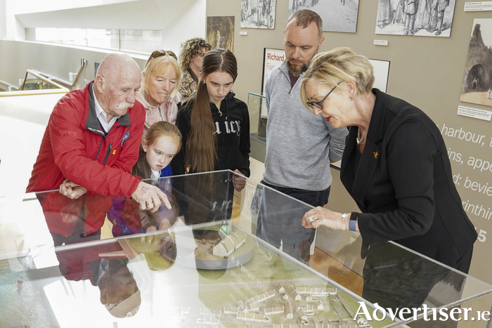 Tommy Holohan and the Holohan family with  Museum Director, Eithne Verling at the model of the Claddagh village at Galway City Museum.