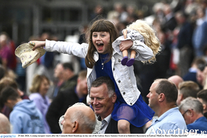 A young racegoer reacts after the Connacht Hotel Handicap on day one of the Galway Races Summer Festival. Photo by Harry Murphy/Sportsfile