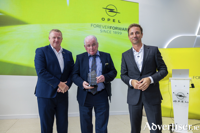 JJ Fleming and Co. were presented with an award from Florian Huettl (right), Opel's global CEO, in recognition of their year's of service to the brand.