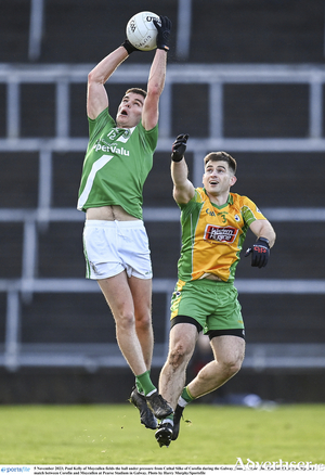 Paul Kelly of Moycullen fields the ball under pressure from Cathal Silke of Corofin during the Galway County Senior Club Football Championship final match between Corofin and Moycullen at Pearse Stadium in Galway.