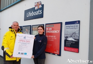 Galway RNLI volunteer crew Mike Swan and Joanne Casserly putting up the poster for the lifeboat station open day on Saturday 28 September from 12-4pm