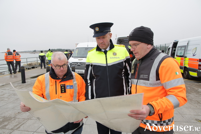 L to R: Brendan Qualter, Civil Defence, Garda Superintendent Paulie O'Shea, and Coast Guard Sector Manager Sean Conroy, co-ordinate the search for a missing swimmer at Silverstrand on Wednesday.  (Photo: Mike Shaughnessy) 