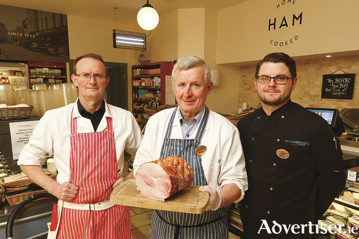 Micky Daly, Liam O'Neill and Matt Moloney from McCambridge's deli with one of its famous Christmas hams. 
Photo:- Mike Shaughnessy. 