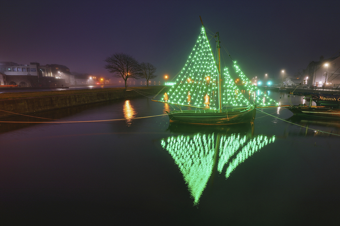 A boat in the Claddagh basin transformed with green lights in solidarity with mental health charity and support service Samaritan's Longest Night event. Photo courtesy of Professor Chaosheng Zhang.