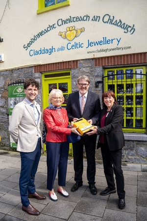 Councillor McNelis presenting a defib to Knocknacarra Active Retirement Club last year.